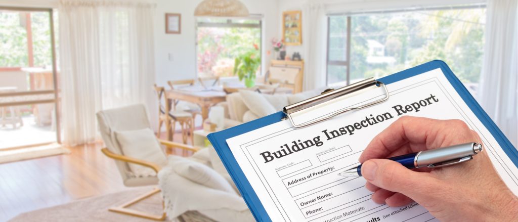 Calgary Home Inspector completing an inspection form on clipboard inside living room